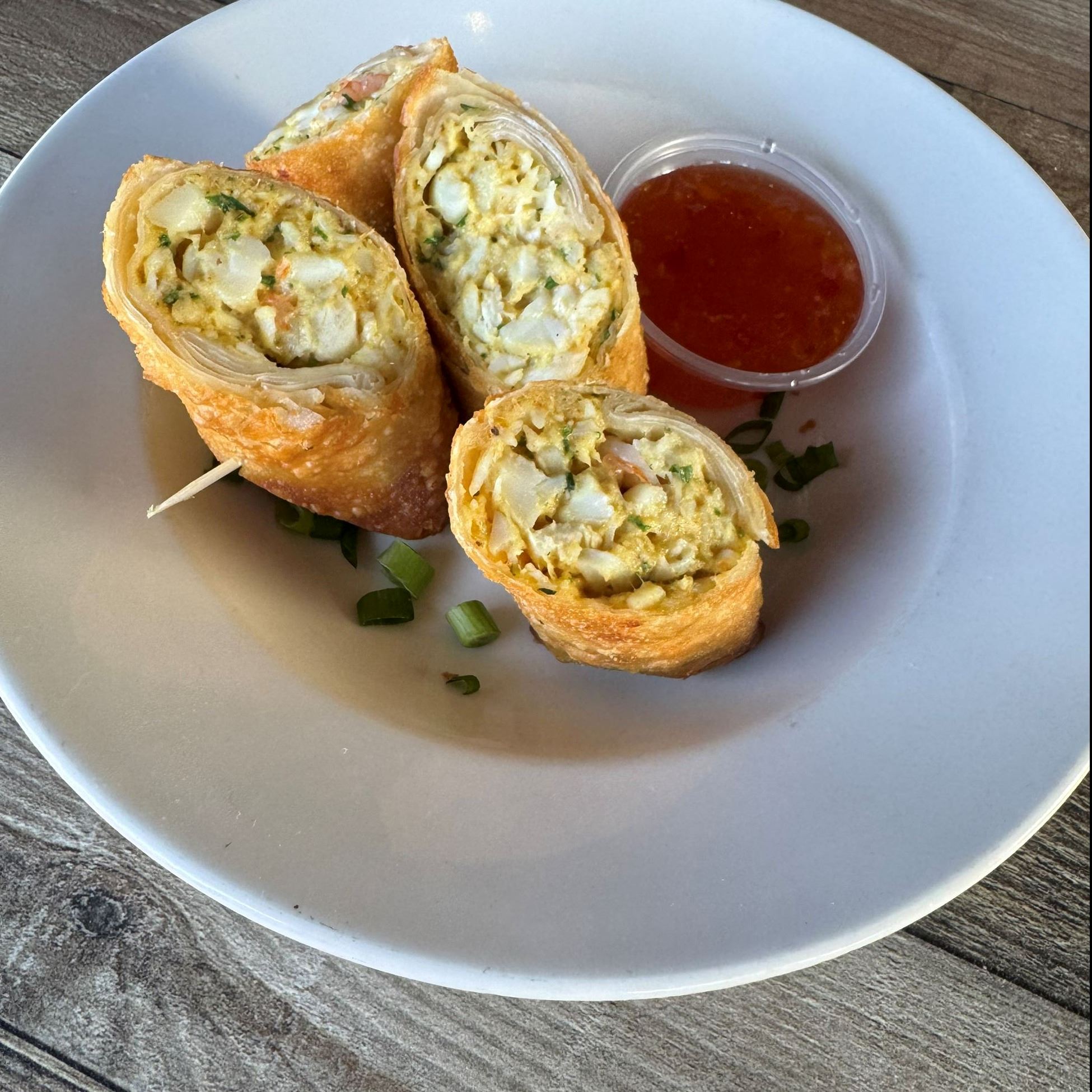 eggs rolls with dipping sauce on a plate