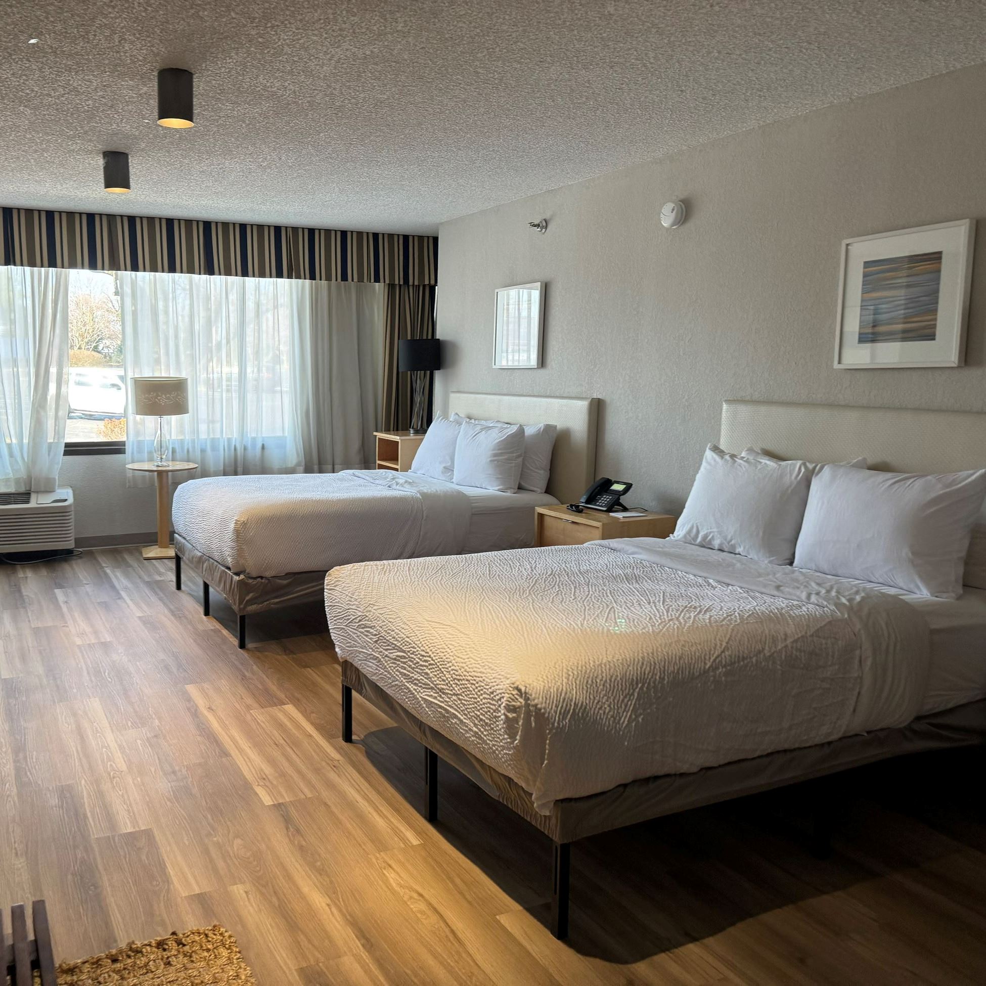 hotel room with two beds and a window